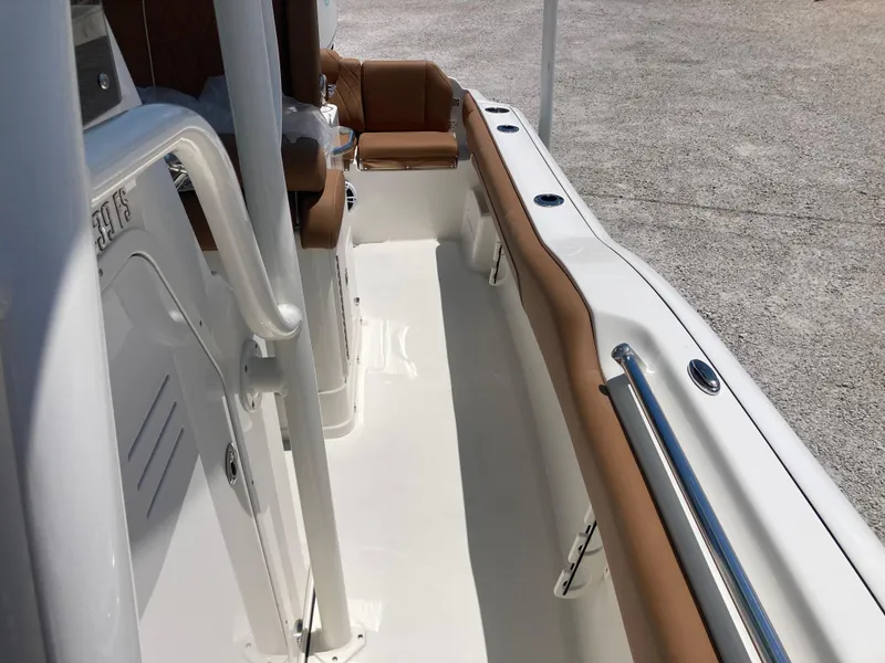 Slide: The Image of 2025 Key West 239FS boat interior with white deck and brown seating. - 13