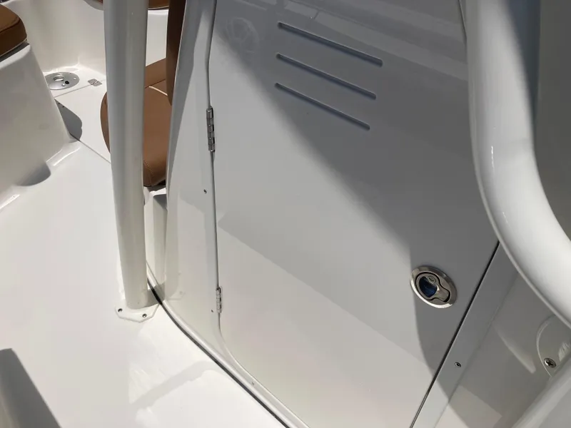 Slide: The Image of 2025 Key West 239FS boat interior, featuring white and brown seating with sleek design elements. - 14
