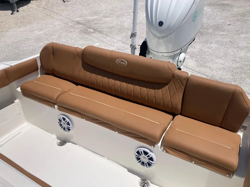 Slide: The Image of 2025 Key West 239FS boat with tan leather seating and built-in speakers. - 18