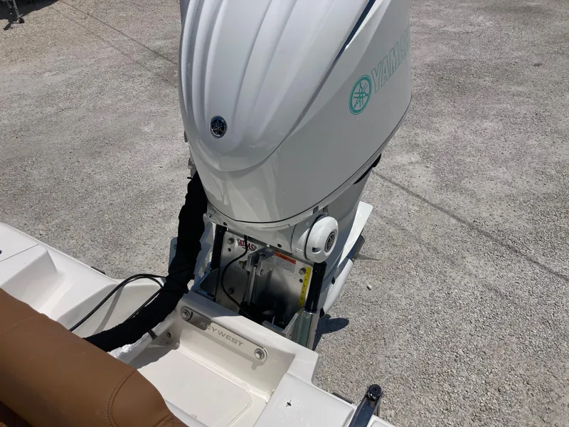 Slide: The Image of 2025 Key West 239FS boat with outboard motor on concrete surface. - 19