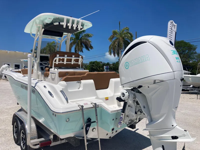 Slide: The Image of 2025 Key West 239FS boat with Yamaha engine, parked on a trailer, palm trees in background. - 3