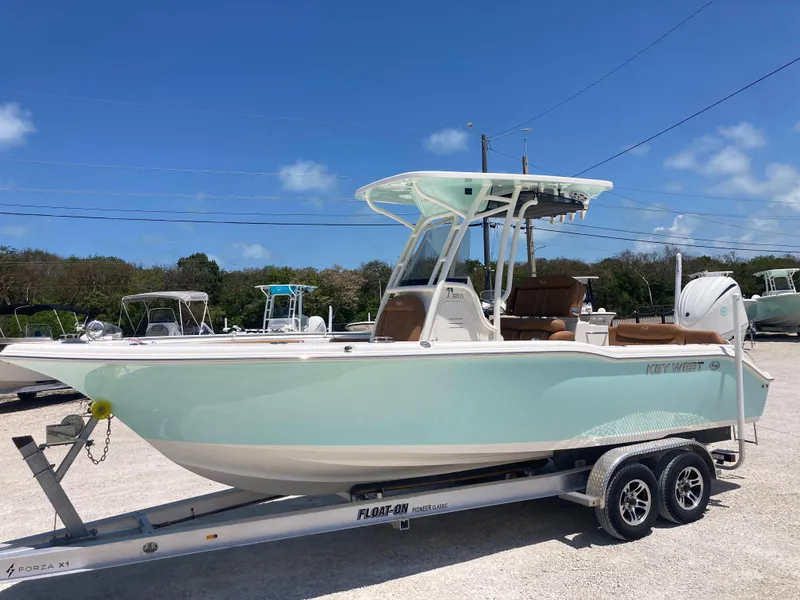 Slide: The Image of 2025 Key West 239FS boat on trailer under clear blue sky. - 4