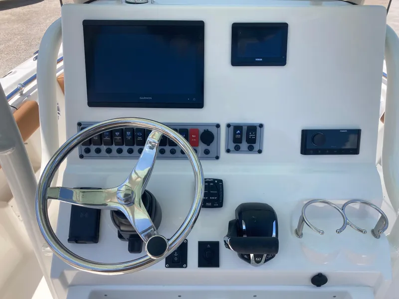 Slide: The Image of 2025 Key West 239FS boat dashboard with steering wheel, controls, and electronic displays. - 7