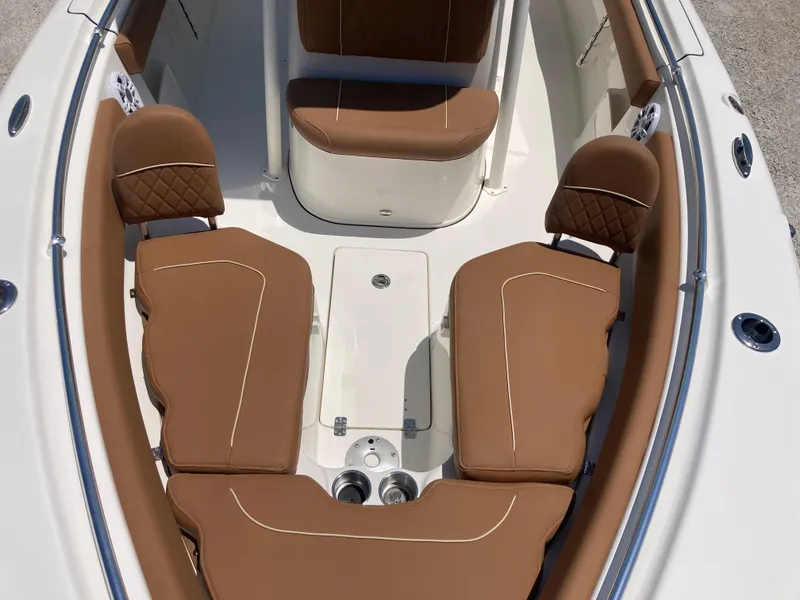 Slide: The Image of 2025 Key West 239FS boat interior with tan cushioned seating and sleek design. - 9