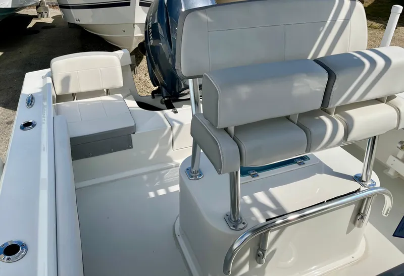 Slide: The Image of 2022 Parker 2100 Special Edition boat interior with cushioned seating and stainless steel fixtures. - 11