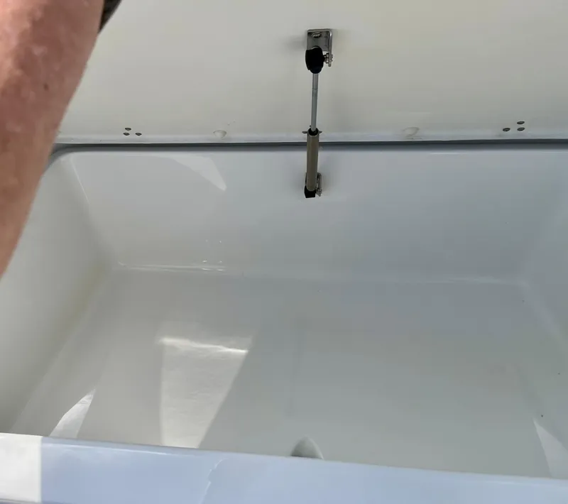 Slide: The Image of Open storage compartment in a 2022 Parker 2100 Special Edition boat. - 12