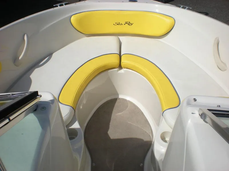Slide: The Image of 2006 Sea Ray 210 Sport boat with yellow seating in the bow area. - 3