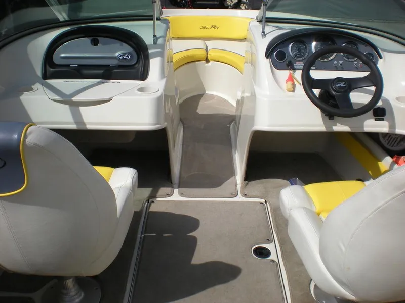 Slide: The Image of Interior of a 2006 Sea Ray 210 Sport boat with yellow and white seating. - 4