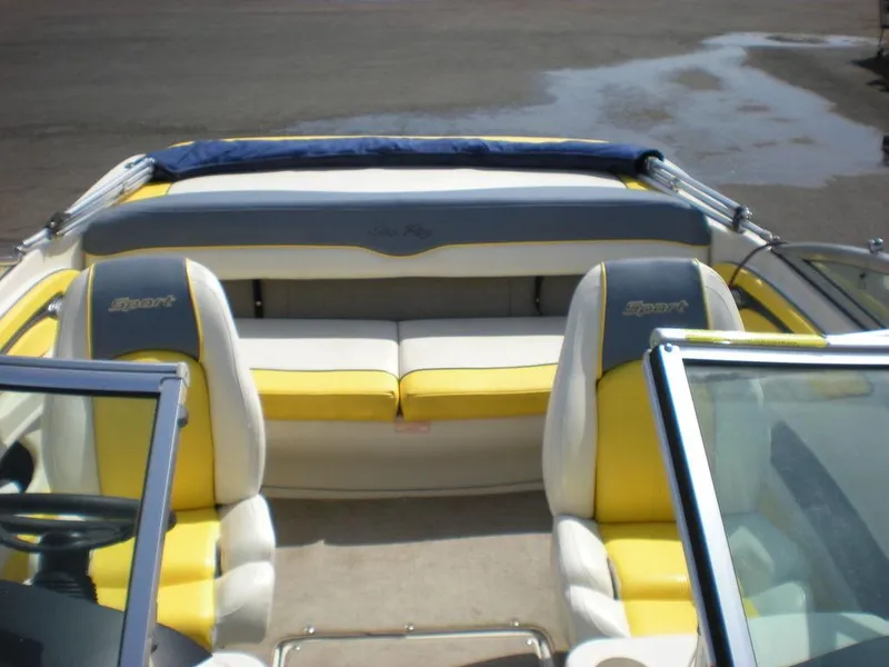 Slide: The Image of 2006 Sea Ray 210 Sport boat interior with yellow and white seating. - 7