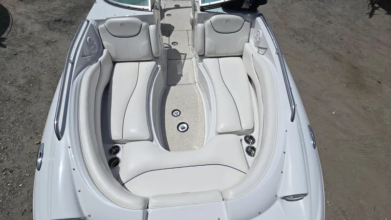Slide: The Image of 2006 Crownline 262 EX boat interior with white seating and cup holders. - 16