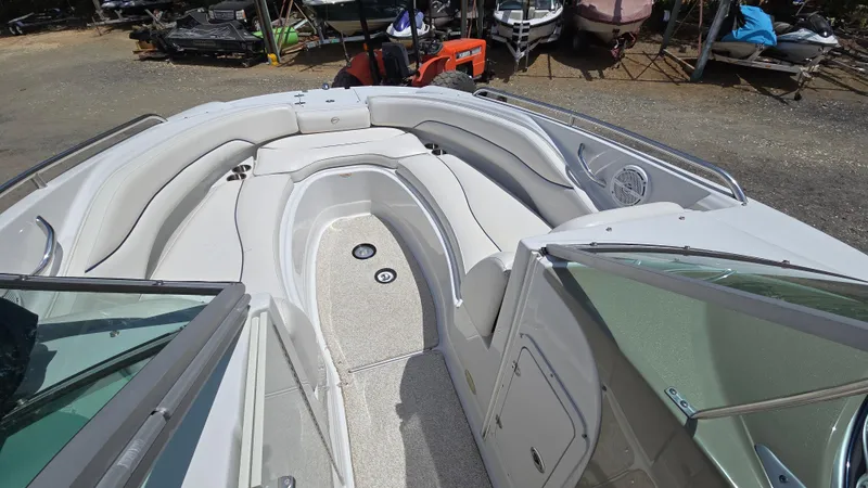 Slide: The Image of 2006 Crownline 262 EX boat interior with spacious seating and open deck layout. - 18