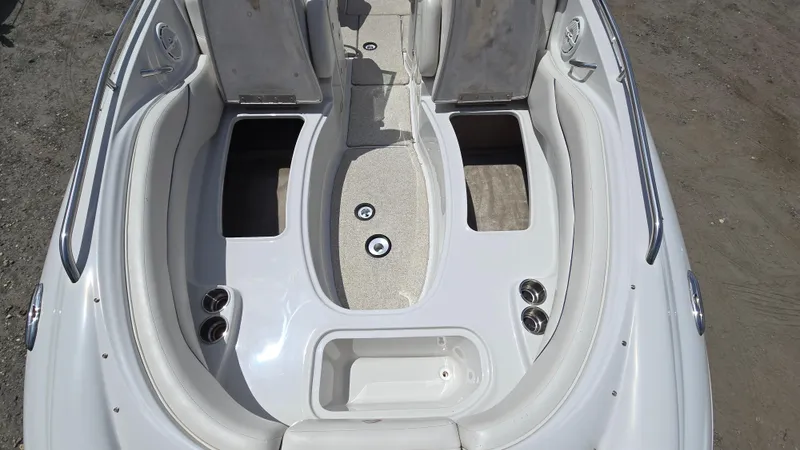 Slide: The Image of 2006 Crownline 262 EX boat interior with open storage compartments and seating. - 19