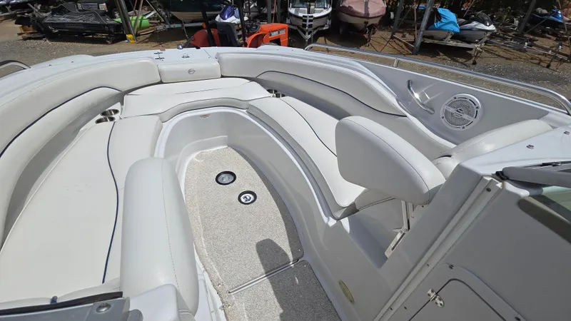Slide: The Image of 2006 Crownline 262 EX boat interior with white seating and deck details. - 20