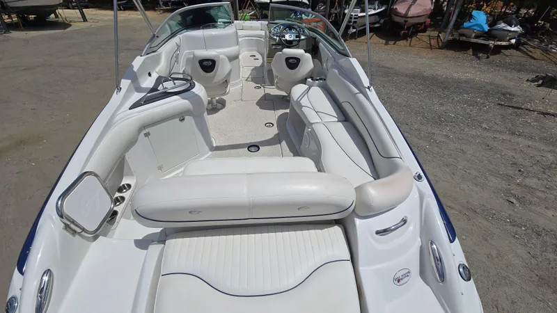 Slide: The Image of 2006 Crownline 262 EX boat interior with white seating and steering console. - 21