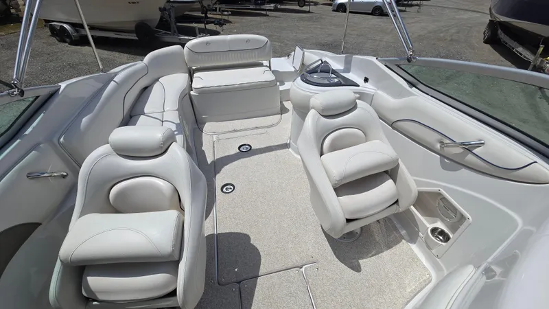 Slide: The Image of 2006 Crownline 262 EX boat interior with white seating and spacious layout. - 22