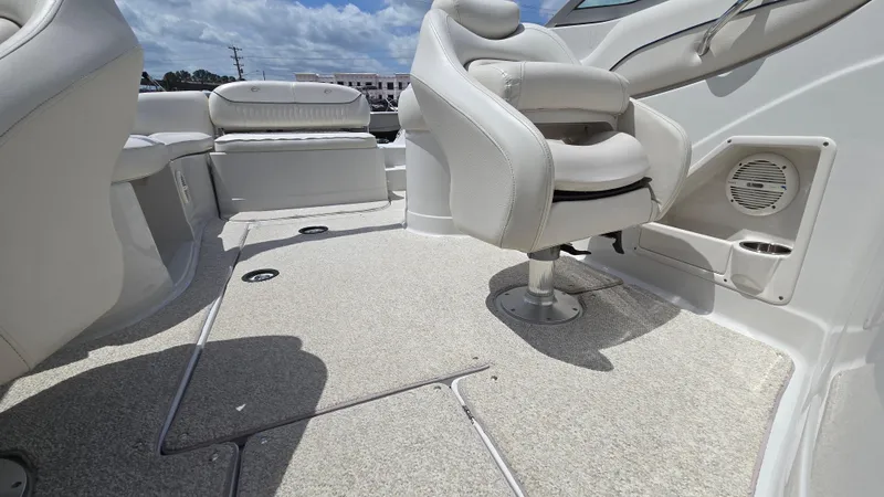 Slide: The Image of 2006 Crownline 262 EX boat interior with white seating and carpeted flooring. - 23