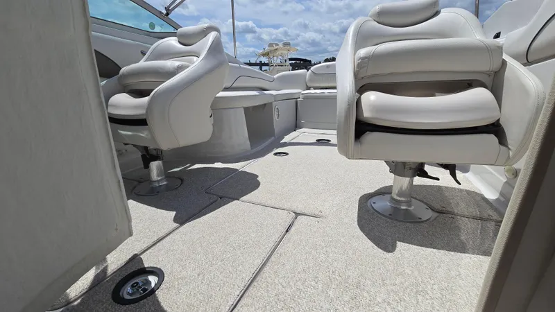 Slide: The Image of 2006 Crownline 262 EX boat interior with plush seating and carpeted flooring. - 24