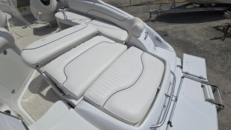Slide: The Image of 2006 Crownline 262 EX boat with white cushioned seating and sleek design. - 26