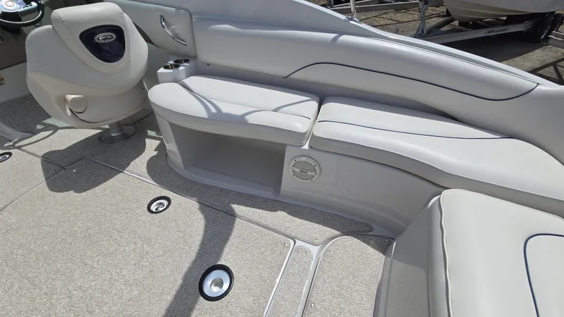 Slide: The Image of 2006 Crownline 262 EX boat interior with white seating and carpeted flooring. - 28