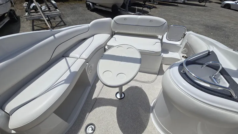Slide: The Image of 2006 Crownline 262 EX boat interior with white seating and round table. - 29