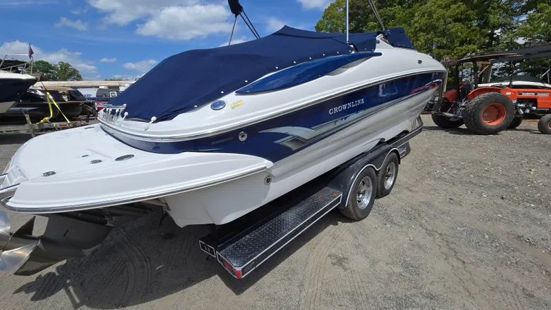 Slide: The Image of 2006 Crownline 262 EX boat on trailer, covered, parked outdoors. - 3