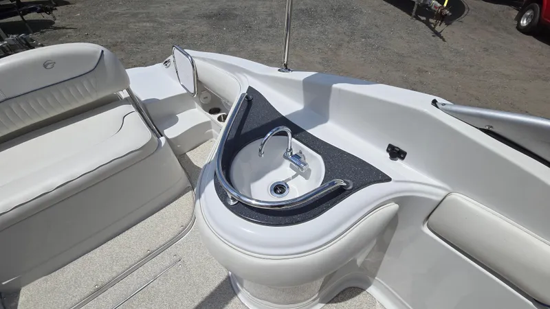 Slide: The Image of 2006 Crownline 262 EX boat interior with sink and seating area. - 30