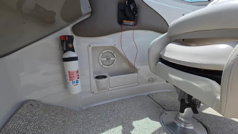Slide: The Image of 2006 Crownline 262 EX boat interior with fire extinguisher, speaker, and seating. - 31