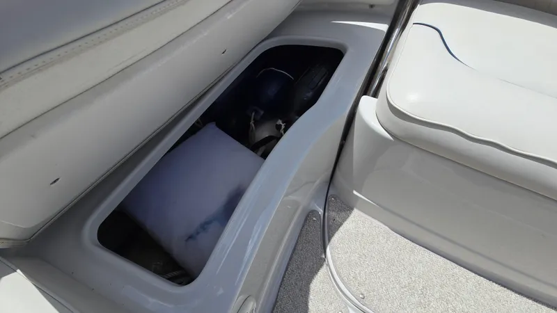Slide: The Image of Open storage compartment in 2006 Crownline 262 EX boat interior. - 32