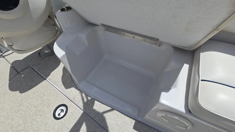 Slide: The Image of 2006 Crownline 262 EX boat interior, featuring seating and storage area. - 33