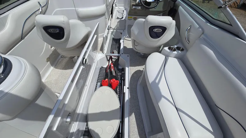 Slide: The Image of 2006 Crownline 262 EX boat interior with open storage compartments and seating. - 35