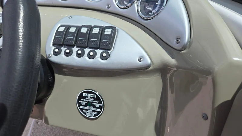 Slide: The Image of Dashboard controls of a 2006 Crownline 262 EX boat, featuring switches and gauges. - 38