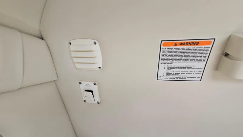 Slide: The Image of 2006 Crownline 262 EX interior with warning label and vent detail. - 42
