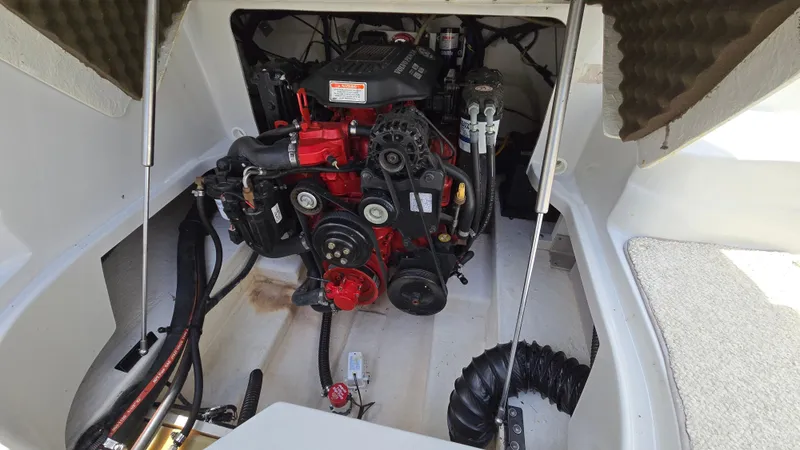 Slide: The Image of Engine compartment of a 2006 Crownline 262 EX boat, showcasing a well-maintained motor. - 44