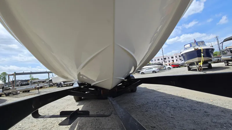 Slide: The Image of 2006 Crownline 262 EX boat on trailer, viewed from below, in a marina setting. - 5