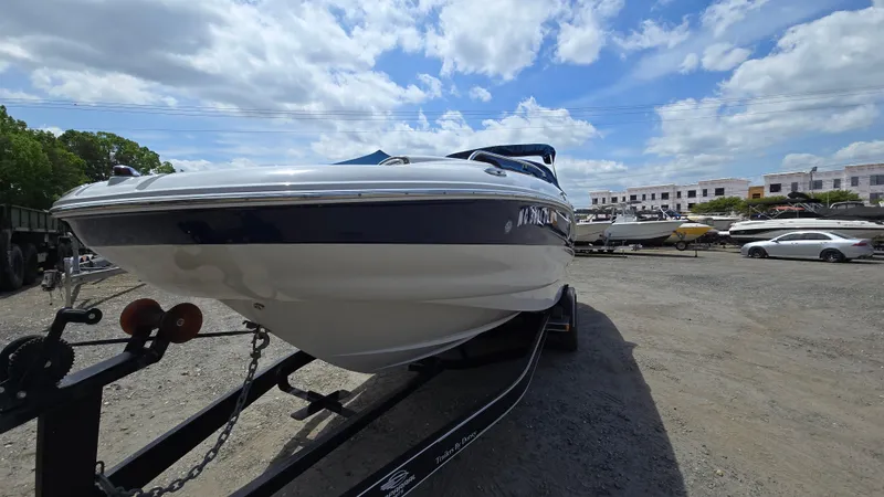 Slide: The Image of 2006 Crownline 262 EX boat on trailer under a partly cloudy sky. - 6