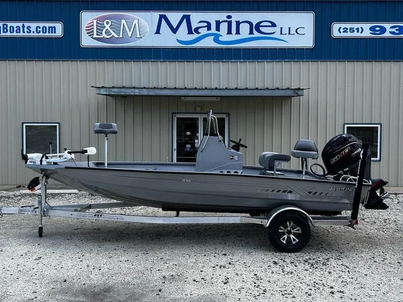 Slide: The Image of 2025 Xpress H190B boat on trailer outside L&M Marine LLC building. - 0
