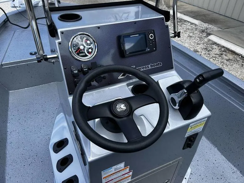 Slide: The Image of 2025 Xpress H190B boat console with steering wheel, gauges, and controls. - 10