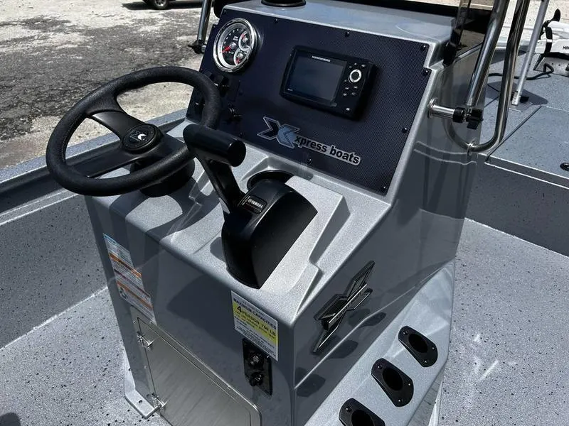 Slide: The Image of 2025 Xpress H190B boat console with steering wheel and control panel. - 11