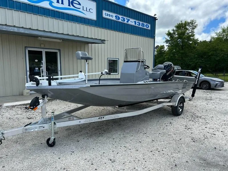 Slide: The Image of 2025 Xpress H190B boat on trailer outside a dealership. - 2
