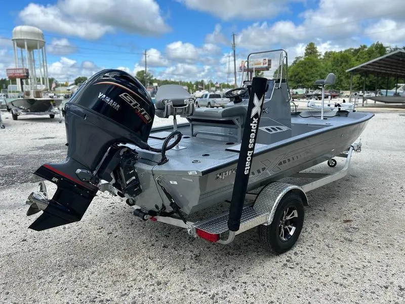 Slide: The Image of 2025 Xpress H190B boat with Yamaha engine on a trailer, parked outdoors. - 4