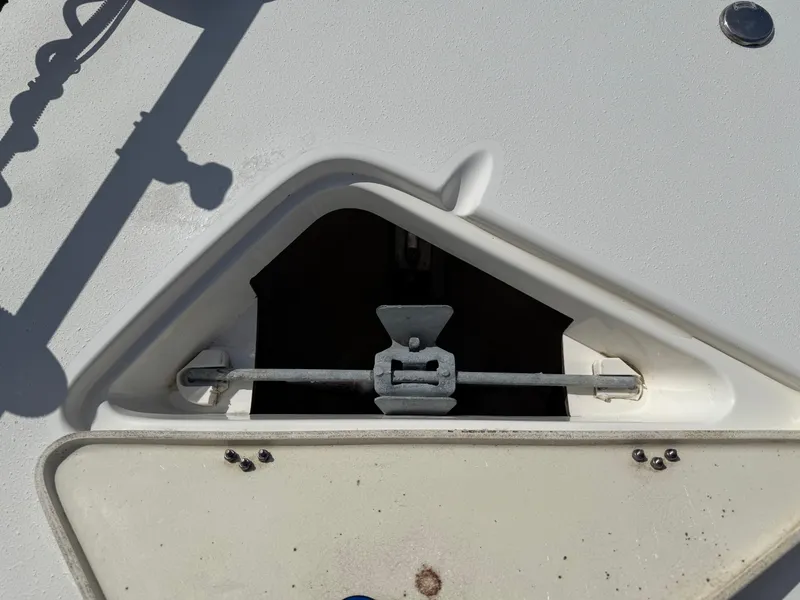 Slide: The Image of 2019 NauticStar 231 Hybrid boat anchor compartment with secured anchor. - 10