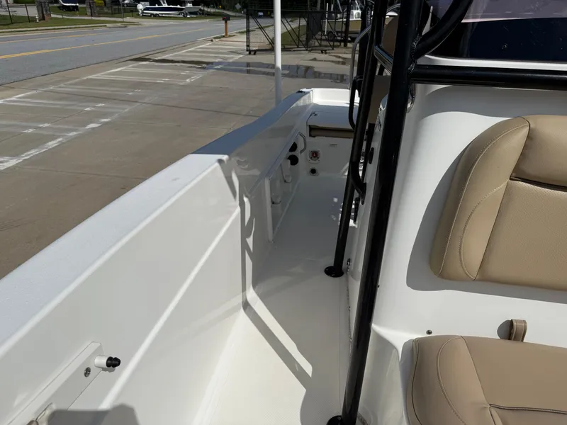 Slide: The Image of 2019 NauticStar 231 Hybrid boat interior with beige seating and white deck. - 11