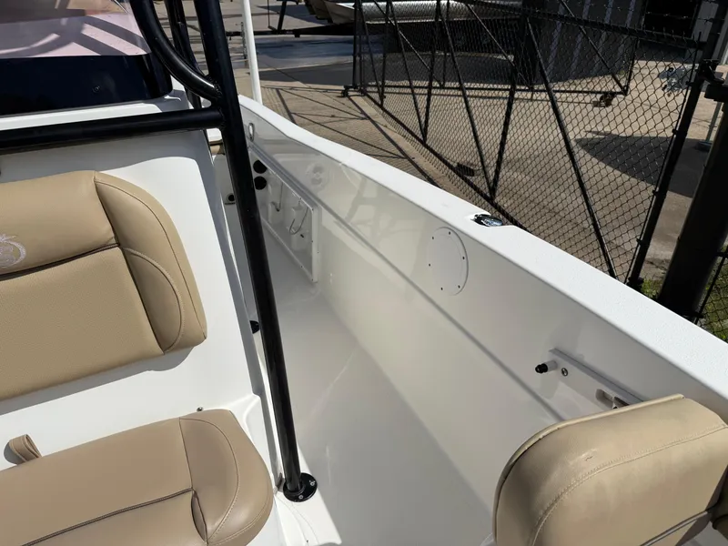 Slide: The Image of 2019 NauticStar 231 Hybrid boat interior with beige seating and white deck. - 12