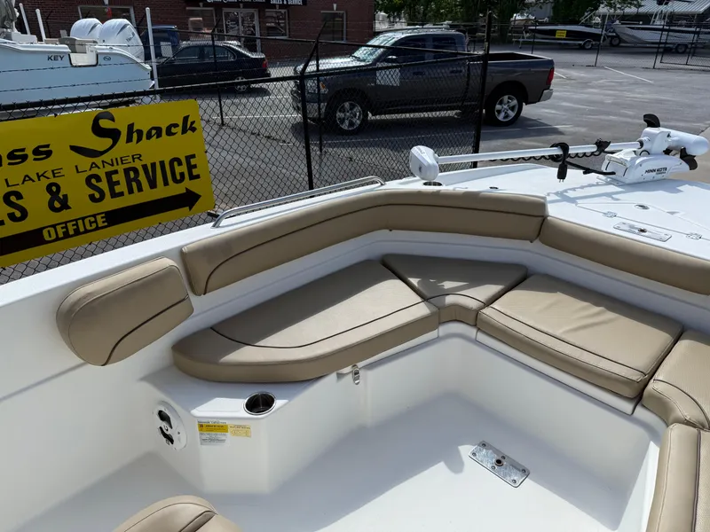 Slide: The Image of 2019 NauticStar 231 Hybrid boat with tan seating and fishing equipment. - 15