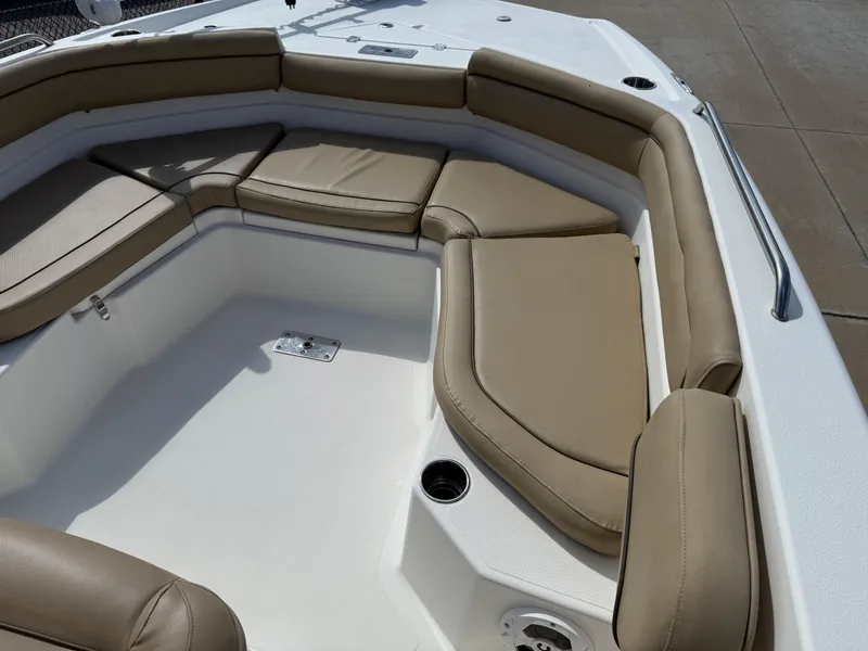 Slide: The Image of 2019 NauticStar 231 Hybrid boat interior with tan cushioned seating. - 16