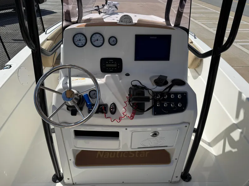 Slide: The Image of 2019 NauticStar 231 Hybrid boat console with steering wheel and gauges. - 21
