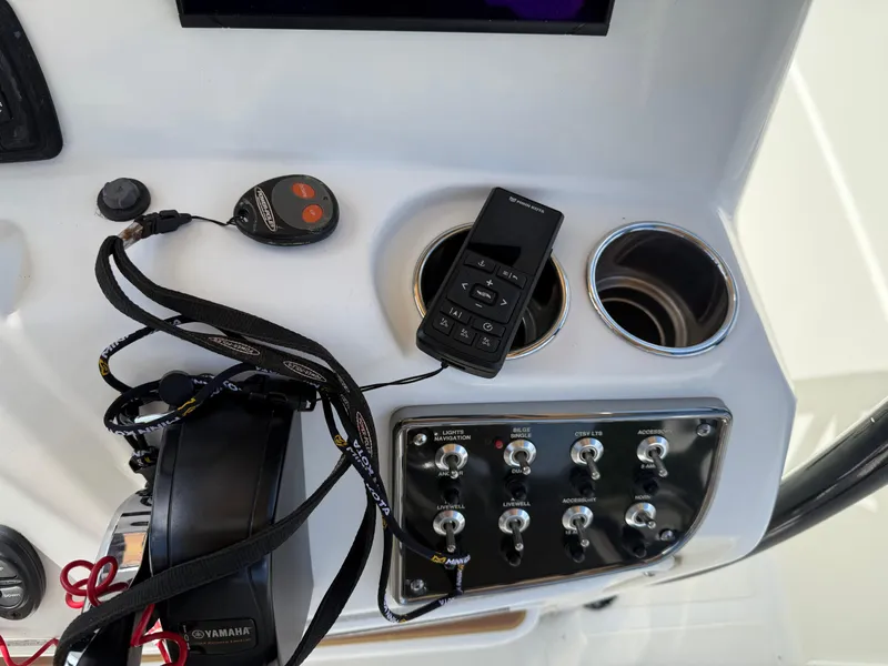 Slide: The Image of Control panel of 2019 NauticStar 231 Hybrid boat with switches and electronics. - 25