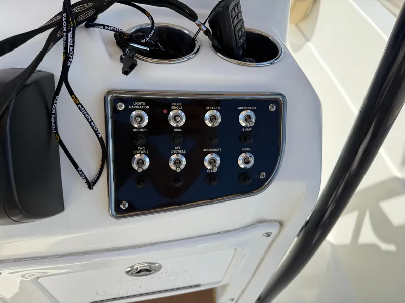 Slide: The Image of Control panel of 2019 NauticStar 231 Hybrid boat with labeled switches. - 26