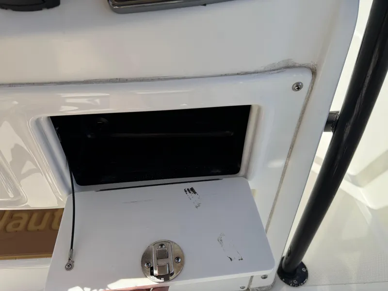 Slide: The Image of 2019 NauticStar 231 Hybrid boat compartment with open hatch and latch. - 27