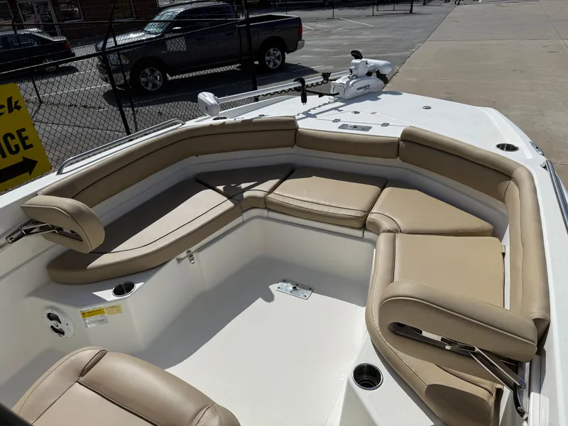 Slide: The Image of 2019 NauticStar 231 Hybrid boat with tan seating and spacious deck layout. - 9
